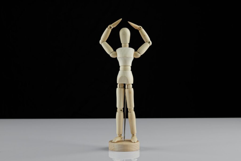 brown wooden human figure on white table