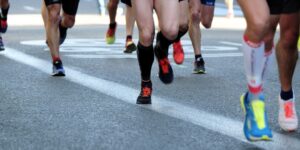 people running on gray asphalt road during daytime