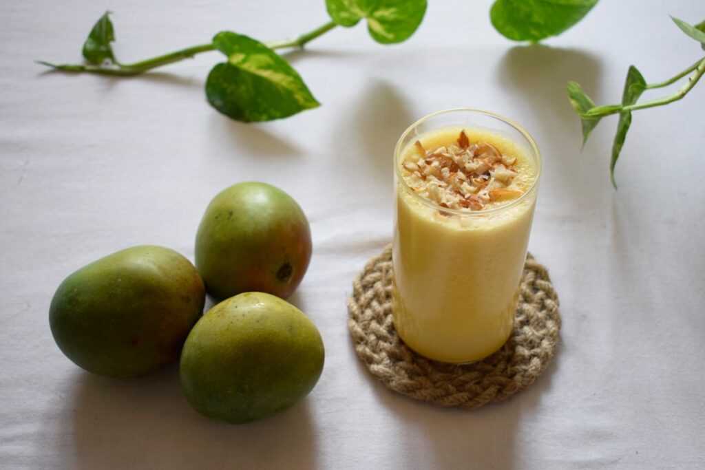 green apple beside clear drinking glass with milk